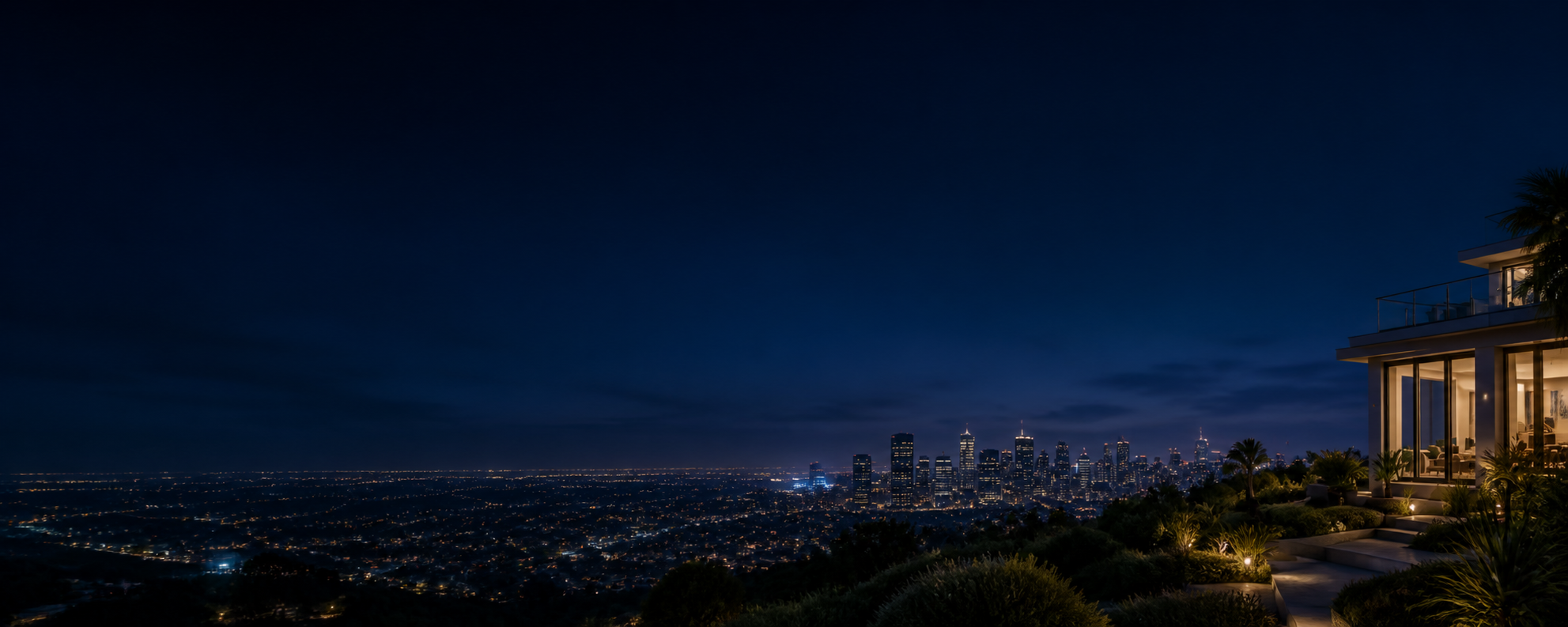 Luxury home overlooking a glowing city skyline at night